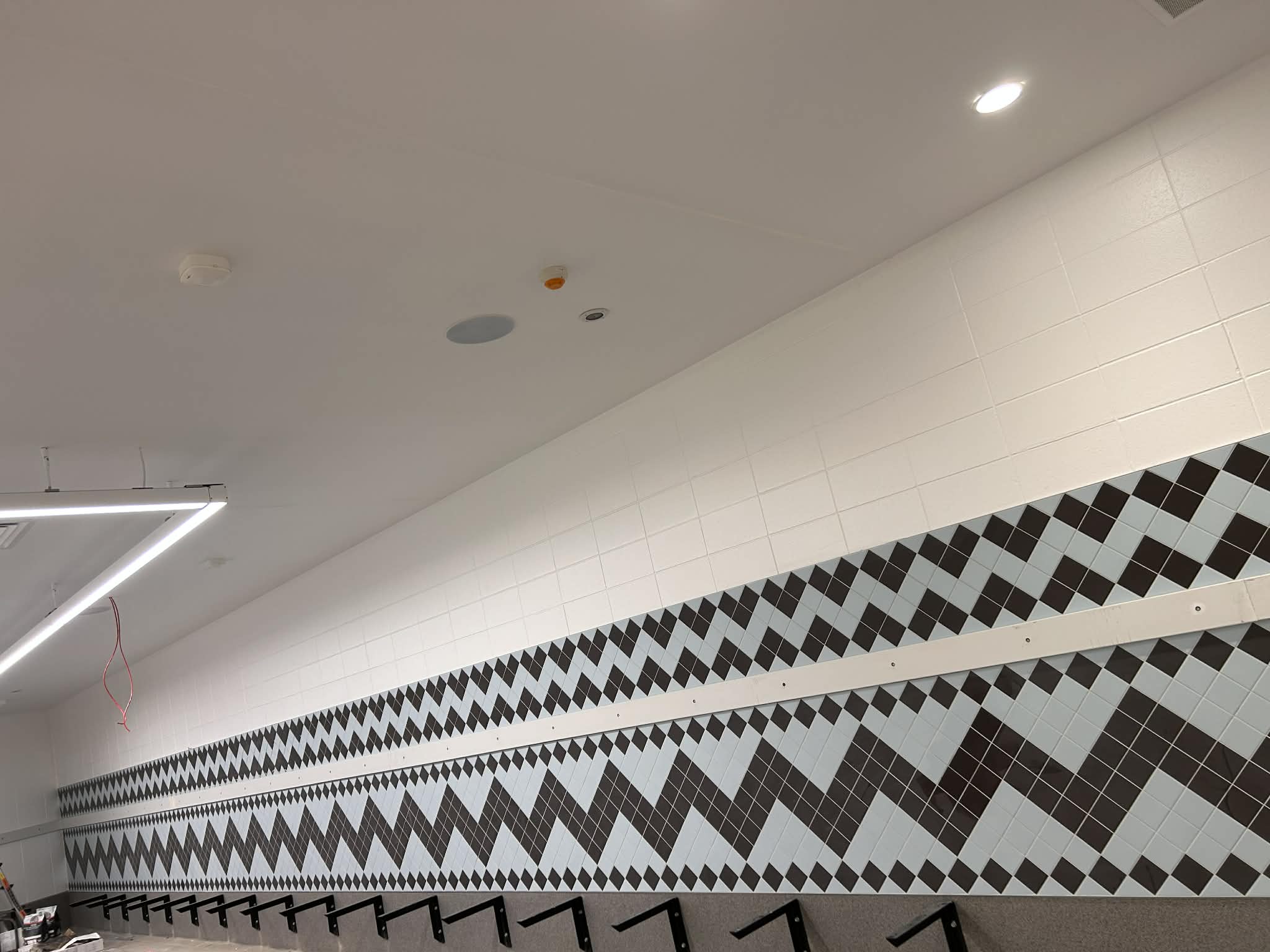 Commercial tiling project with black and white geometric diamond pattern wall tiles — Wellington commercial space